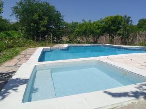 an empty swimming pool in the middle of a yard at Fred Hunter Villa in Tiwi