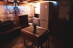 a small kitchen with a table and a refrigerator at Vintage Lozenets Apartment in Sofia