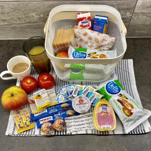 a basket full of food and snacks on a table at Villa Oliver 1 Hévíz in Hévíz