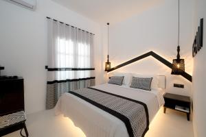 Ένα ή περισσότερα κρεβάτια σε δωμάτιο στο Divelia Hotel