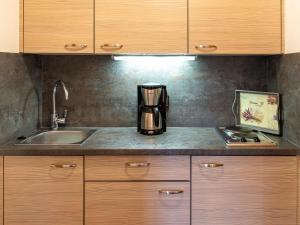a kitchen with a sink and a coffee maker on a counter at Strohmayer Appartements in Bad Endorf