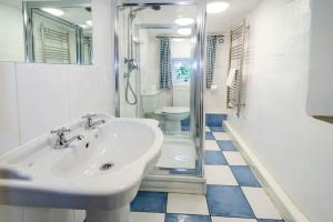 a bathroom with a sink and a shower and a toilet at Pye Howe in Ambleside