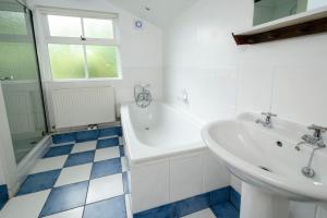 a bathroom with a sink and a tub and a sink at Pye Howe in Ambleside