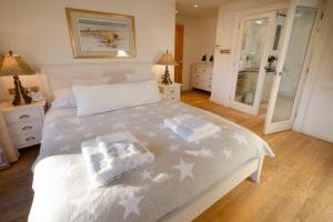 a bedroom with a white bed with stars on it at River House, Clappersgate, Ambleside in Ambleside