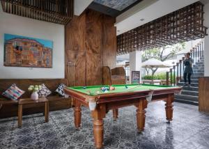 a room with a pool table and a couch at PATIO Hotel & Urban Resort in Phnom Penh