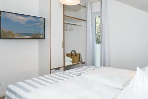 Ein Bett oder Betten in einem Zimmer der Unterkunft Upstalsboom Residenzen Trassenheide