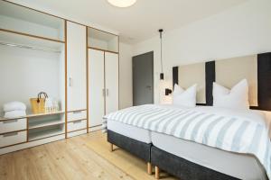 Ein Bett oder Betten in einem Zimmer der Unterkunft Upstalsboom Residenzen Trassenheide