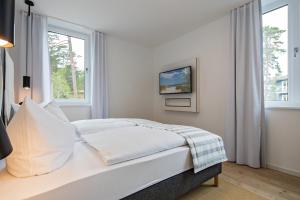 Ein Bett oder Betten in einem Zimmer der Unterkunft Upstalsboom Residenzen Trassenheide