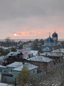a city with snow covered roofs and a mosque at Apartament Sulina in Sulina