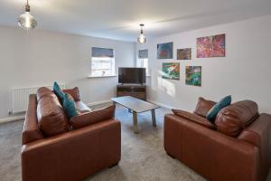 a living room with two leather couches and a table at Host & Stay - Bagdale Rise in Whitby