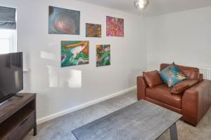 a living room with a couch and paintings on the wall at Host & Stay - Bagdale Rise in Whitby
