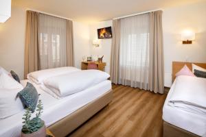 Postel nebo postele na pokoji v ubytování Hotel am Peterstor