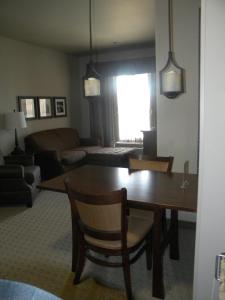 a living room with a dining room table and a couch at Teddy's Residential Suites Watford City in Watford City