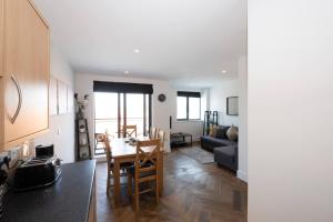 a kitchen and living room with a table and a couch at Air Host and Stay - Liverpool The Atrium sleeps 6 great value in Liverpool