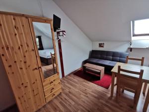 a living room with a couch and a table at Pension U Jelinka in Nové Hamry