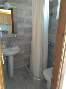 a bathroom with a sink and a toilet and a shower at Panorama Plati in Platy