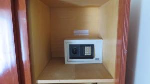 a microwave in a cabinet in a room at Hotel Principe in Buenos Aires