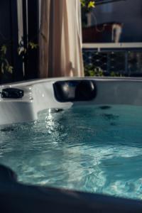 a white bath tub filled with blue water at Villa Jadran in Promajna