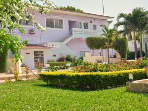 a house with a garden in front of it at Pelican Residence in Fajara