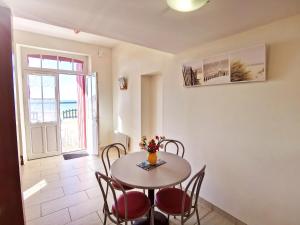 a dining room with a table and chairs at Appartements la Félicité in Saint-Gilles-Croix-de-Vie