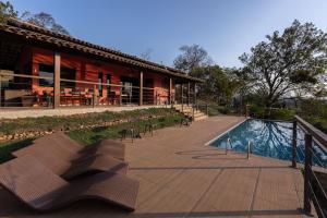 a building with a swimming pool next to a resort at Villa Severina in Brumadinho