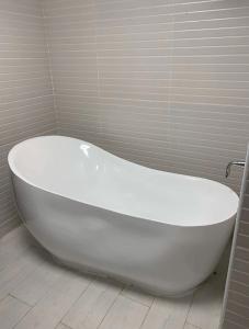 a large white bath tub in a bathroom at Bay la sun , Luxury apartment with nice view in King Abdullah Economic City