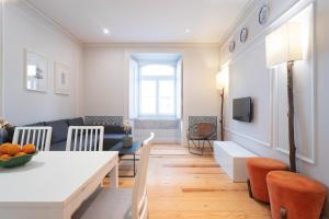 a living room with a table and a couch at Baixa Cozy 2BR with AC - by LU Holidays in Lisbon