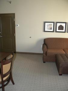 a living room with a couch and a chair at Teddy's Residential Suites Watford City in Watford City