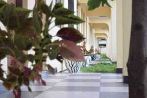 a hallway of a building with vases with plants at Remarkable 10-Bed Cottages in Bagamoyo in Bunju