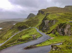 a winding road on the side of a mountain at Cosy sea view cottage Isle of Skye in Colbost