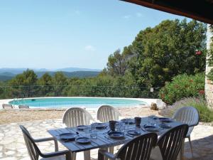 een eettafel en stoelen voor het zwembad bij Peaceful spacious 3 bed Villa in Callian