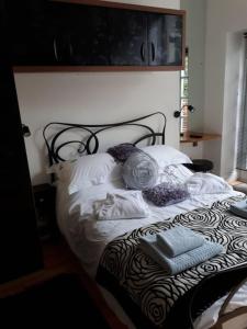 - un lit avec des draps et des oreillers blancs dans l'établissement Hollies and Ilfracombe Harbour View, à Ilfracombe