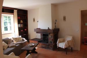 a living room with a couch and a fireplace at Appartements de Chantaco in Saint-Jean-de-Luz