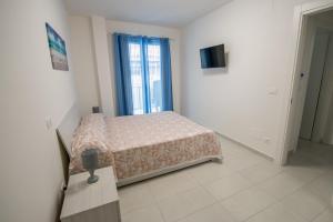 a bedroom with a bed and a television in it at Home Square in Milazzo