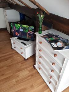 a bedroom with a dresser with a television on it at Cozy apartment in Galway 60 m² city view in Galway +27 photos