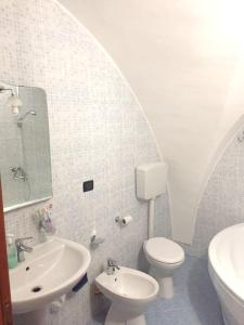 a white bathroom with a toilet and a sink at Modern Apartment in Gallipoli with Air Conditioning in Gallipoli +23 photos