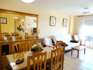 a living room with a couch and a dining room at Comfortable Apartment in Dénia + Pool in Denia