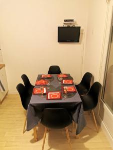 a table with black chairs and a black table cloth at Appartement d'une chambre avec balcon a Cauterets in Cauterets