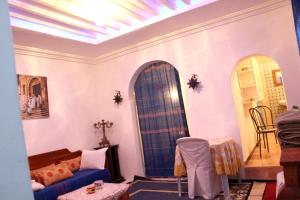 a living room with a blue surfboard on the wall at 2 bedrooms apartement with terrace and wifi at Tunis 4 km away from the beach in Tunis