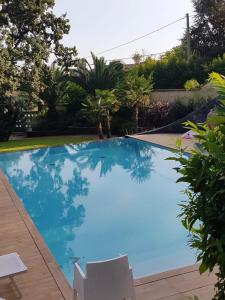 a large blue swimming pool in a yard at Studio with shared pool enclosed garden and wifi at Trecastagni 8 km away from the beach in Trecastagni