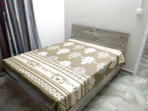 a bed with a blanket on it in a room at Charming House in Curepipe + Garden in Curepipe