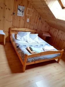 a bed in a wooden room in a attic at Appartement de 3 chambres avec balcon et wifi a Vars a 2 km des pistes in Vars