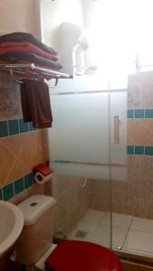 a bathroom with a shower and a toilet and a sink at Maison d'une chambre avec piscine privee jacuzzi et jardin clos a Le Moule in Le Moule