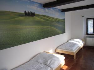 two beds in a room with a painting on the wall at Chata Bucharka in Liberec