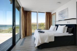 A bed or beds in a room at NOVI Resort