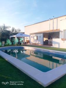 a swimming pool in front of a house at 4 bedrooms house with private pool enclosed garden and wifi at Montilla Cordoba in Jarata