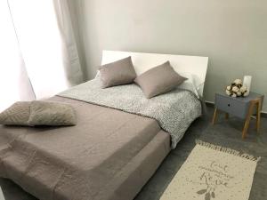 a bed with two pillows on it in a bedroom at Maison d'une chambre avec vue sur la mer jardin clos et wifi a Le Moule a 3 km de la plage in Le Moule