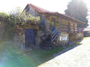 una casa in pietra con una scala accanto a un muro di pietra di One bedroom house with shared pool enclosed garden and wifi at Agueda a Urgueira