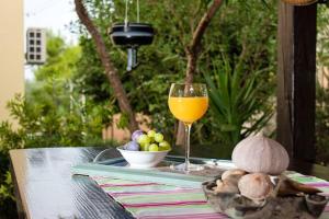 a table with a glass of orange juice and a bowl of fruit at 2 bedrooms appartement with wifi at Trogir in Trogir