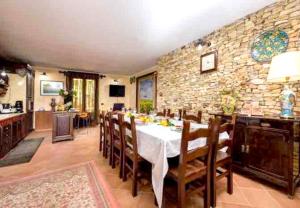 a dining room with a table and a stone wall at 4 bedrooms villa with private pool jacuzzi and enclosed garden at Partinico 9 km away from the beach in Partinico